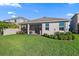 The backyard offers a lush lawn and a covered patio at 12637 Promenade Estates Blvd, Sarasota, FL 34238