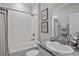 Well-lit bathroom featuring a granite countertop, a tub and shower, and neutral decor at 12637 Promenade Estates Blvd, Sarasota, FL 34238