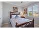 This bedroom features a shuttered window and a traditional aesthetic at 12637 Promenade Estates Blvd, Sarasota, FL 34238