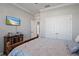 This bedroom has a TV and a view to the bedroom next door at 12637 Promenade Estates Blvd, Sarasota, FL 34238