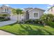 Home exterior featuring a two-car garage with manicured landscaping at 12637 Promenade Estates Blvd, Sarasota, FL 34238