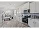 Modern kitchen featuring granite countertops, stainless steel appliances, and a tile backsplash at 12637 Promenade Estates Blvd, Sarasota, FL 34238