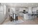 Open kitchen with white cabinets, granite counters, stainless steel appliances, and adjacent dining area at 12637 Promenade Estates Blvd, Sarasota, FL 34238