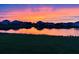 Picturesque sunset reflecting over a tranquil lake surrounded by homes at 12637 Promenade Estates Blvd, Sarasota, FL 34238