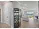 Hallway view into open floor plan with decorative shelving and living area with lake view at 12637 Promenade Estates Blvd, Sarasota, FL 34238