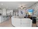 An open floor plan showcasing the kitchen, living, and dining areas, plus a view of a stone accent wall at 12637 Promenade Estates Blvd, Sarasota, FL 34238