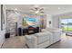 Bright living room with fireplace, stone accent wall, media console, and sliding doors that open to an outdoor patio at 12637 Promenade Estates Blvd, Sarasota, FL 34238