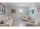 Cozy living room featuring natural light and comfortable seating at 12637 Promenade Estates Blvd, Sarasota, FL 34238