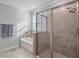 This bright main bathroom features a shower, separate tub, and neutral tile at 12637 Promenade Estates Blvd, Sarasota, FL 34238