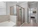 The main bath features neutral tile, glass shower, and separate soaking tub at 12637 Promenade Estates Blvd, Sarasota, FL 34238