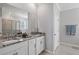 This main bathroom features a double sink vanity with granite counters and a glass door shower at 12637 Promenade Estates Blvd, Sarasota, FL 34238