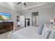 Spacious main bedroom with a mounted TV and a view to the main bathroom at 12637 Promenade Estates Blvd, Sarasota, FL 34238