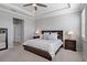 This main bedroom features a tray ceiling, ceiling fan, and neutral decor at 12637 Promenade Estates Blvd, Sarasota, FL 34238