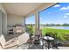 Covered patio with grill, outdoor furniture and views of a lake at 12637 Promenade Estates Blvd, Sarasota, FL 34238