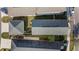 A top-down view of houses with green yards and dark gray rooftops, neatly arranged in a neighborhood at 12679 Sagewood Dr, Venice, FL 34293