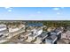 Beautiful aerial view of a residential neighborhood with a lake and lush greenery under a blue sky at 12679 Sagewood Dr, Venice, FL 34293