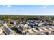 Aerial view of a neighborhood showcasing the community, mature trees and a lake at 12679 Sagewood Dr, Venice, FL 34293