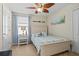 Comfortable bedroom with coastal decor, ceiling fan, and bright natural light at 12679 Sagewood Dr, Venice, FL 34293