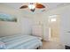 Comfortable bedroom featuring coastal decor, a ceiling fan, and a built-in closet at 12679 Sagewood Dr, Venice, FL 34293