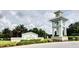 Welcoming entrance to the Grand Palm community, featuring lush landscaping and stylish signage at 12679 Sagewood Dr, Venice, FL 34293