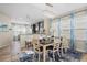Elegant dining area featuring a modern chandelier and view of kitchen and dining area at 12679 Sagewood Dr, Venice, FL 34293