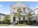 Charming two-story home with a welcoming front porch and lush tropical landscaping at 12679 Sagewood Dr, Venice, FL 34293