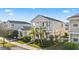 Attractive two-story home with a quaint front porch surrounded by a lush green lawn at 12679 Sagewood Dr, Venice, FL 34293