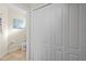 Bright hallway with tile flooring and linen closet leading to half bathroom at 12679 Sagewood Dr, Venice, FL 34293
