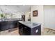 Modern kitchen with a granite countertop island and stainless steel appliances at 12679 Sagewood Dr, Venice, FL 34293