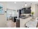 Modern kitchen with granite countertops, stainless steel appliances, and stylish barstool seating at 12679 Sagewood Dr, Venice, FL 34293