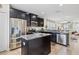 Modern kitchen with stainless steel appliances and a granite countertop island at 12679 Sagewood Dr, Venice, FL 34293