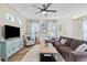 Comfortable living room featuring stylish furnishings, a ceiling fan, and ample natural light at 12679 Sagewood Dr, Venice, FL 34293
