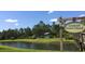 Picturesque pond with kayak and canoe storage, surrounded by lush greenery and nature trails at 12679 Sagewood Dr, Venice, FL 34293