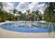 A colorful splash pad area surrounded by palm trees and lush landscaping, perfect for Gathering fun at 12679 Sagewood Dr, Venice, FL 34293
