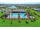 An aerial view of a large community pool with lounge chairs and a grilling area at 13309 Ipolita St, Venice, FL 34293