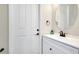 This bathroom features a round mirror and a vanity at 13652 Classico Ct, Venice, FL 34293