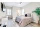 The bedroom features light wood flooring, a ceiling fan, and natural light at 13652 Classico Ct, Venice, FL 34293