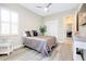 The bedroom features light wood flooring, a ceiling fan, and closet at 13652 Classico Ct, Venice, FL 34293