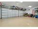Spacious three car garage featuring organized storage, and epoxy flooring to display the vehicles at 13652 Classico Ct, Venice, FL 34293
