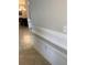 Neutral hallway with picture-frame style trim and tile flooring at 13652 Classico Ct, Venice, FL 34293