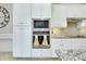 Well-equipped kitchen featuring stainless steel appliances and crisp white cabinetry at 13652 Classico Ct, Venice, FL 34293