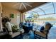 Inviting screened lanai with comfortable seating, view of the pool, and beautiful lake view at 13652 Classico Ct, Venice, FL 34293