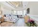 Main bedroom with ample natural light and tray ceiling at 13652 Classico Ct, Venice, FL 34293