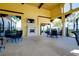 Inviting outdoor lounge area with a fireplace, TV, and comfortable seating for residents at 13652 Classico Ct, Venice, FL 34293