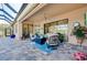 Cozy outdoor patio featuring comfortable seating, ceiling fan, and views of lush landscaping, great for gatherings at 13652 Classico Ct, Venice, FL 34293