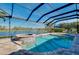 Beautiful screened-in pool and hot tub overlooking a serene lake view, perfect for relaxation and entertaining at 13652 Classico Ct, Venice, FL 34293