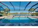 Gorgeous screened pool and hot tub with a stunning lake view, offering a tranquil outdoor experience at 13652 Classico Ct, Venice, FL 34293