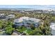Beautiful aerial view of the spacious home featuring pristine landscaping, a private beach, and panoramic views at 14 Grouper Hole Dr, Boca Grande, FL 33921