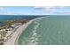 Breathtaking aerial view of the beachfront, displaying pristine sands and turquoise waters, perfect for relaxation at 14 Grouper Hole Dr, Boca Grande, FL 33921