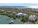 Stunning aerial view of waterfront home with private dock and gulf access and beautiful beach in the distance at 14 Grouper Hole Dr, Boca Grande, FL 33921